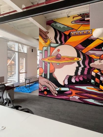 Another angle of the finished mural, showing how it wraps around the corner and interacts with the office architecture.