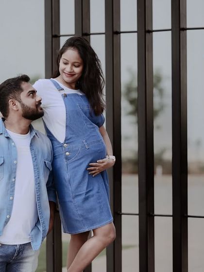 A casual and modern maternity shoot. The couple's denim outfits and relaxed poses create a stylish and contemporary portrait.