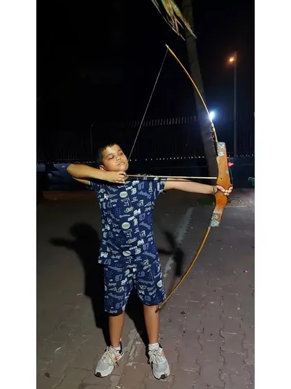 A young boy practices his form during a night session. Our well-lit ranges allow for flexible training schedules.