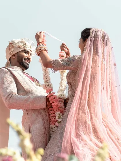 A playful moment during the varmala exchange, capturing the fun and loving dynamic of the couple. These are the memories that last a lifetime.