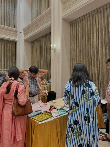 A shopper tries on a shirt at a stall. Providing space and opportunity for customers to try products is key to driving sales.