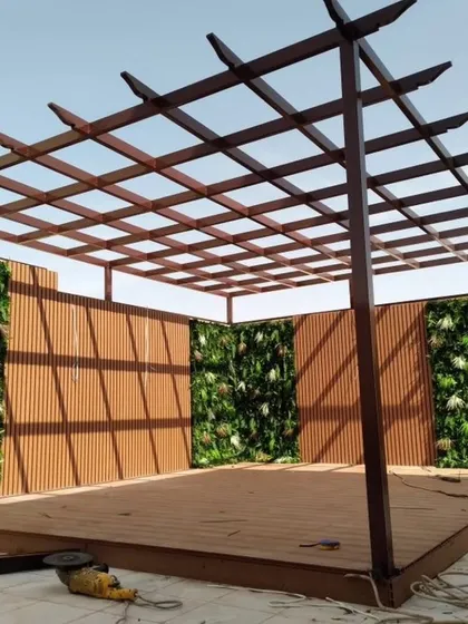 This work-in-progress shot shows the versatility of our designs. Here, we are building a pergola with an integrated WPC deck and flanking it with framework for vertical green walls to create a private, nature-filled enclosure.