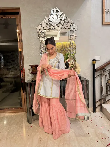 Adjusting the dupatta of my sharara set. The light and airy fabric makes it easy to move around and enjoy the festivities.