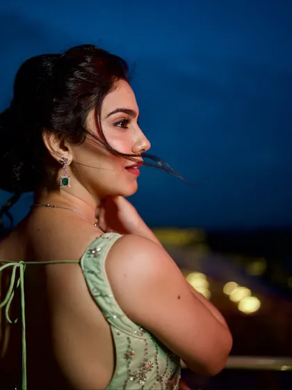 A back profile shot, with the wind catching my hair. The open-back blouse adds a modern touch to the traditional saree.