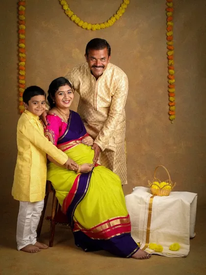 Celebrating tradition and new life. This family chose a beautiful ethnic theme for their maternity shoot, with the older brother lovingly touching his mother's baby bump.