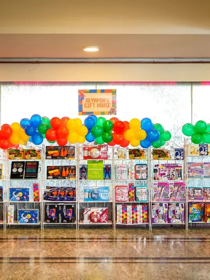 A large display of return gifts for the LEGO-themed party.