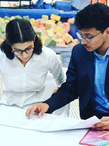 Our team meticulously reviewing scores and performance sheets. We are deeply invested in the progress of every athlete.