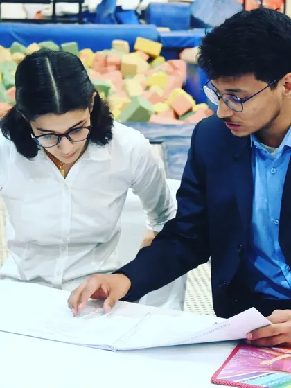 A moment of discussion between two judges, ensuring accuracy in scoring. Professionalism is key in every role.