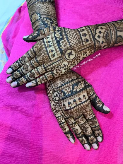 A clear shot of the back of the hands, highlighting the symmetry and the clean, precise linework. The floral and geometric bands are perfectly balanced.