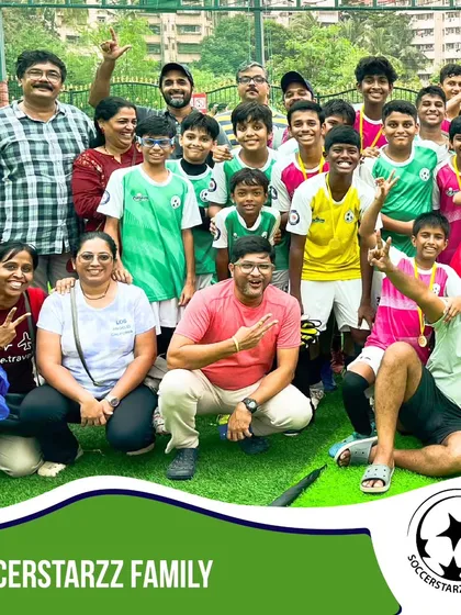 The SoccerStarzz family celebrating together after a successful tournament. Players, parents, and coaches united in victory.