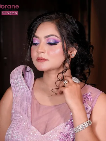 A beautiful portrait showcasing the intricate floral details on the gown and the complementary purple eye makeup.