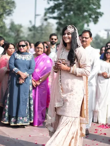 The bride, surrounded by her family, looking on with anticipation.