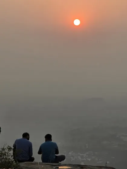 There's a special peace in watching the sunrise from a hilltop. Here are two trekkers enjoying a quiet morning at Minchukallu Betta after a night of camping.