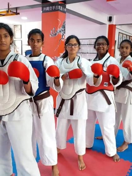 A group of our female students ready for Kumite (sparring) practice. They are equipped with protective gear, ensuring a safe and effective training session.