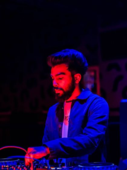 A close-up shot of me mixing, with the red and blue club lights creating a cool, dual-tone effect.