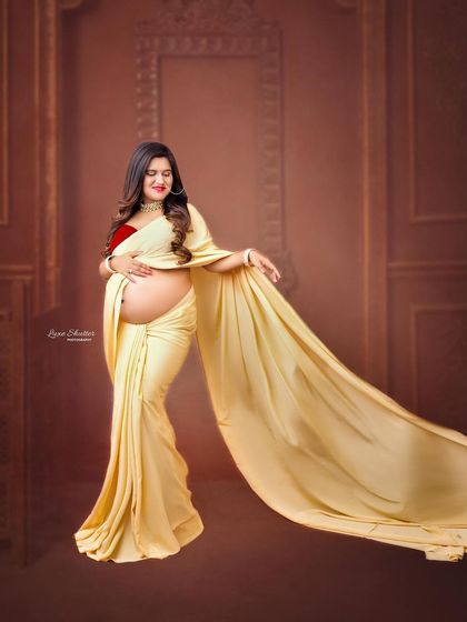 A full-length view of the modern saree drape against a classic, architectural background. This style offers a unique blend of tradition and high-fashion photography.