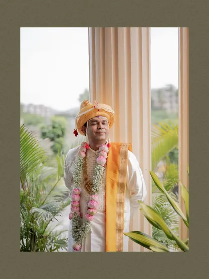 A serene portrait of the groom in his traditional Maharashtrian wedding attire, with his eyes closed as if soaking in the moment.