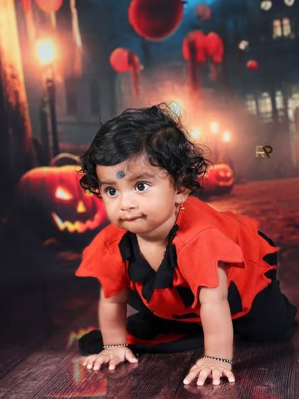 Another shot from the Halloween session, capturing the baby's curious expression. The atmospheric lighting and spooky props create a fun and memorable first Halloween portrait.