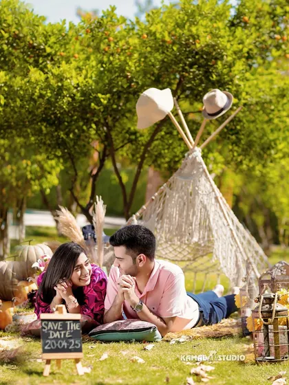 A cozy, themed picnic setup complete with a 'Save the Date' sign. We love incorporating personal details and creative concepts to make your pre-wedding shoot a fun, memorable experience that reflects your personality.