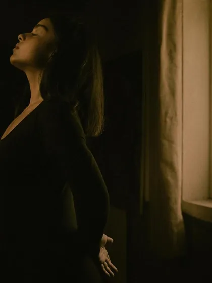 An artistic, moody shot by a window. This photo captures the introspective and creative solitude that is a crucial part of my process as a musician.