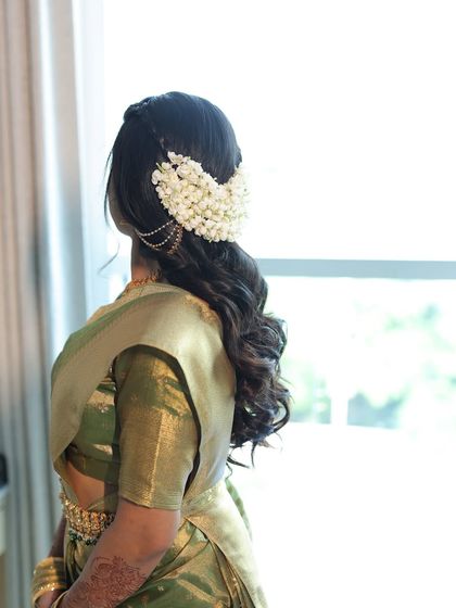 Another angle of the gajra and soft waves hairstyle. This look is perfect for a bride who wants a blend of traditional and contemporary styles.