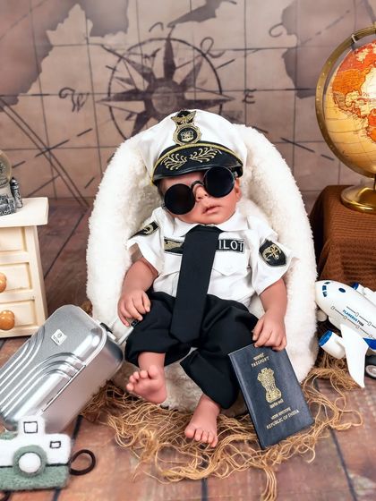 Our handsome little pilot, ready to fly the friendly skies. Themed shoots for twins allow us to showcase their individual personalities while telling a cohesive story.