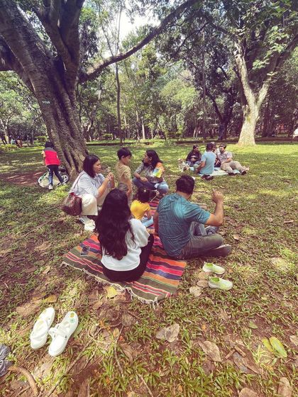 A father gives a thumbs-up in the background as the story session unfolds. We love seeing parents enjoy the experience, making it a true family activity and a great weekend outing in Bangalore.