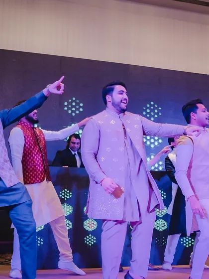 The groom and his friends pointing to the crowd. We teach moves that engage the audience and make the performance interactive.