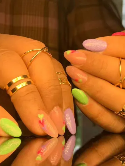A soft and artistic pastel design with abstract splashes of green, purple, and pink.