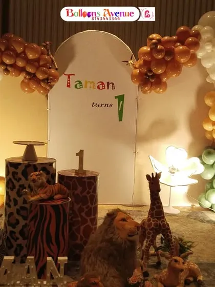 A full view of the safari stage for Taman's first birthday, illuminated for an evening event.
