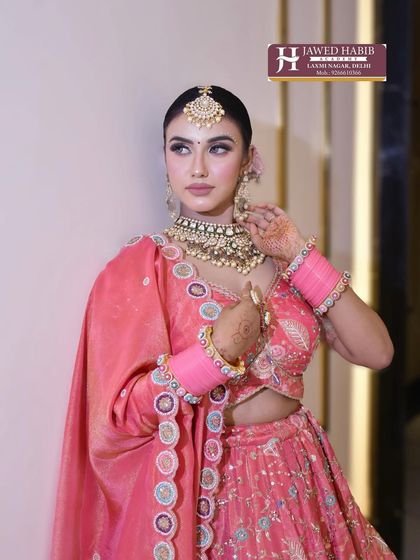 A final look at this beautiful bride in her pink lehenga, showcasing the complete styling from a different angle. We ensure our students master looks that are perfect from every viewpoint.