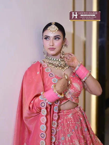 A model poses in a complete pink bridal ensemble. This showcases the final result of our training, where students learn to create portfolio-worthy images that attract clients.
