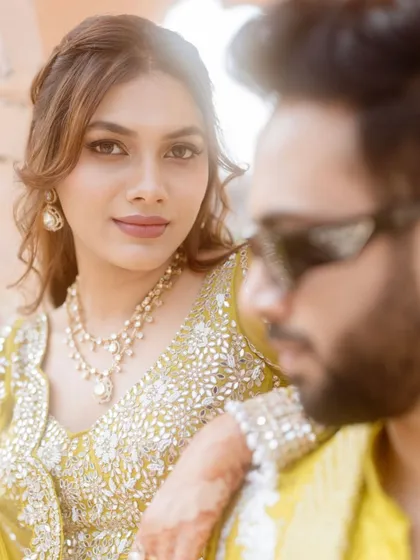 A cool and stylish shot of the couple at their carnival. The bride's makeup is fresh and minimal, perfect for a sunny day.
