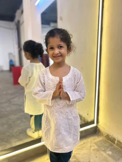 A student in a simple white kurta, ready for her Independence Day performance. We believe in celebrating every occasion with dance.