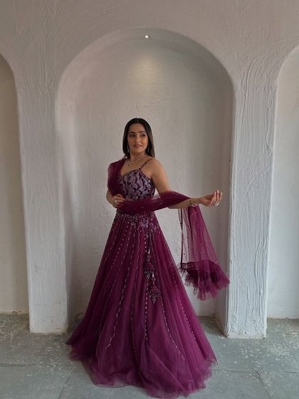 The full view of this gorgeous wine-colored lehenga. The flowing net skirt and embellished blouse create a beautiful silhouette.