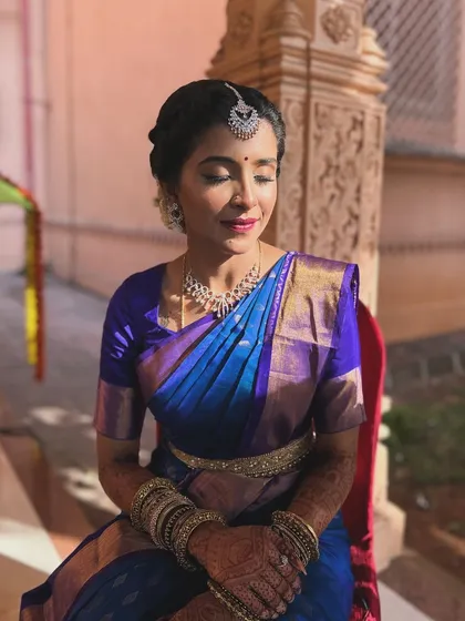 A serene moment captured in the soft sunlight. This photo highlights the smooth, skin-like finish of the makeup, a key element of my bridal service.