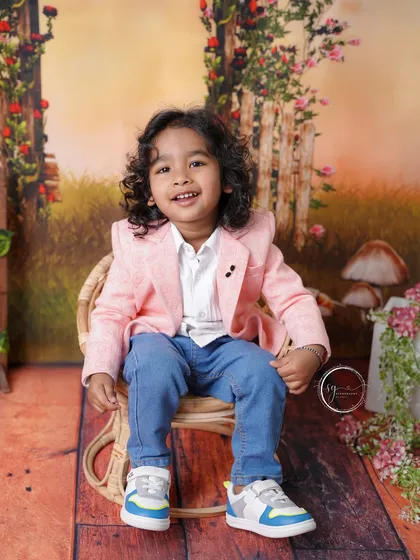 A close-up portrait that captures his bright, joyful smile and the smart details of his outfit.