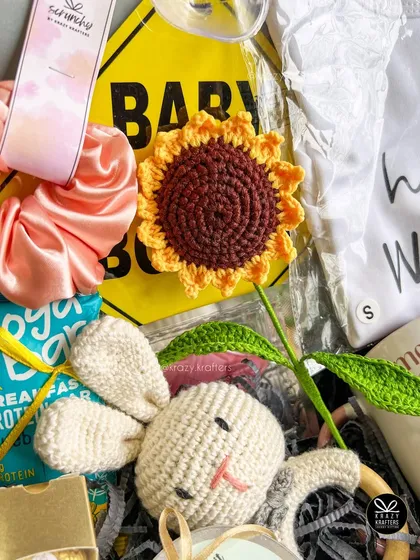 A detail shot of the handmade crochet sunflower and bunny rattle from a parents-to-be hamper. I love including unique, handcrafted items.