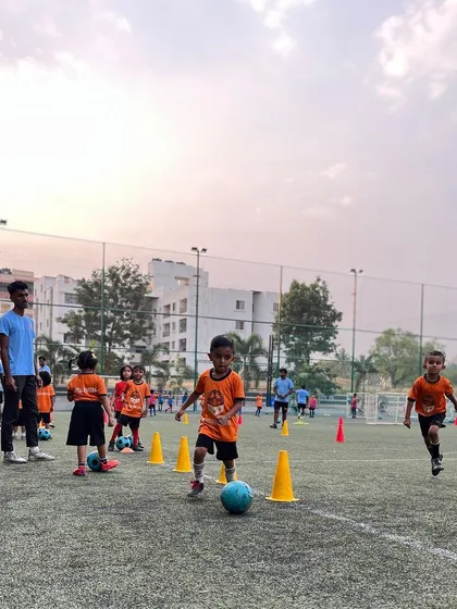 Dribbling through cones, our little Lions learn ball control in a playful and encouraging setting.