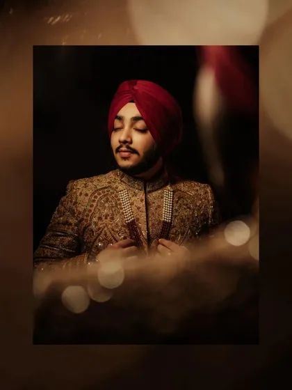 A moody, artistic portrait of Prabneet, his eyes closed, with soft bokeh lights creating a cinematic and introspective feel.