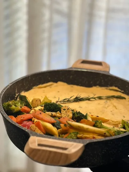 A pan of creamy vegetables ready to be served. I believe in food that tastes as good as it looks, using fresh ingredients and beautiful cookware.
