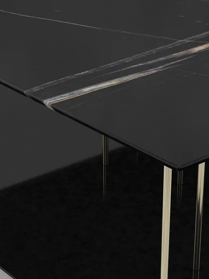 A close-up of the black marble top, showing the beautiful natural veining and the clean, sharp edges of this contemporary center table.