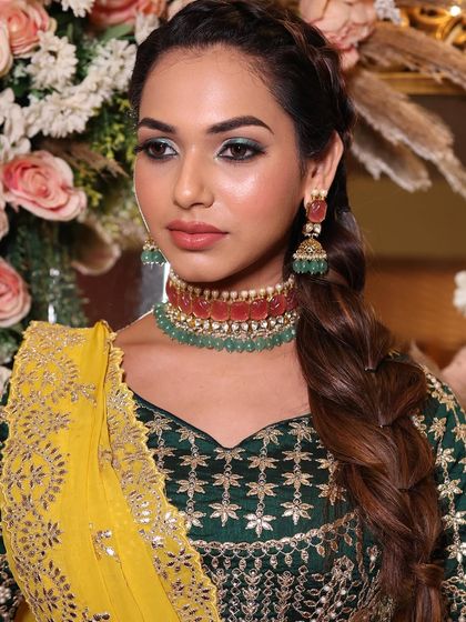 A direct gaze that is both captivating and confident. The green eye makeup is expertly blended to be dramatic yet elegant.