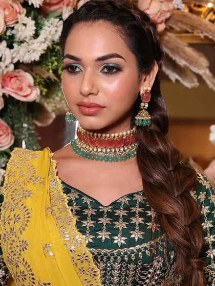A direct gaze that is both captivating and confident. The green eye makeup is expertly blended to be dramatic yet elegant.