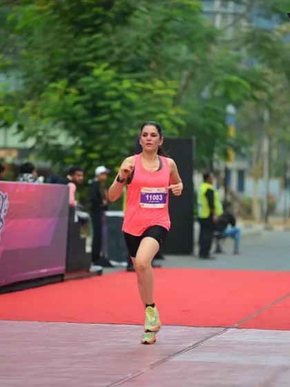 Dr. Indu Tandon in full stride, crossing the finish line during a competitive race. This image captures the focus and determination that has led her to over 90 podium finishes across India.