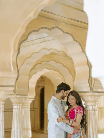 An intimate moment shared between the grand pillars of a Jaipur palace. I look for these quiet corners to capture the subtle, romantic interactions that truly define a couple's bond.