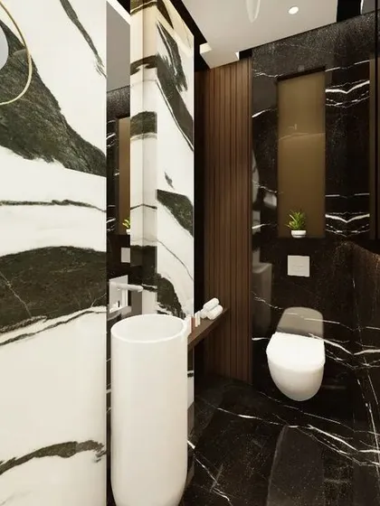 Another angle of the bespoke powder washroom, showcasing the bold interplay of different marbles. The design thoughtfully places mirrors to enhance the sense of space and reflect the rich patterns of the stone.