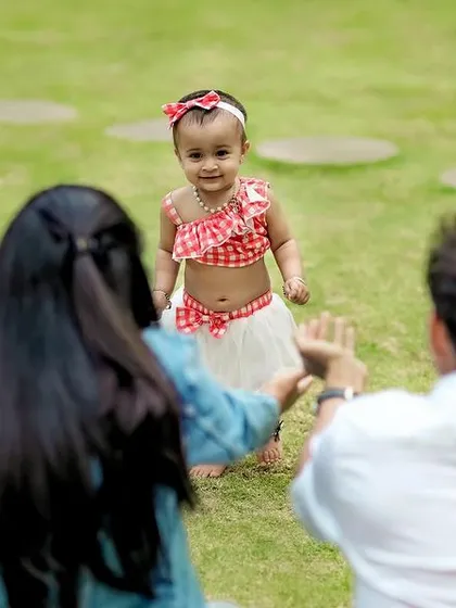 Those precious first steps. We captured this beautiful, unscripted moment as this little girl walks towards her parents' open arms during a relaxed outdoor family session. These are the memories we live to capture.