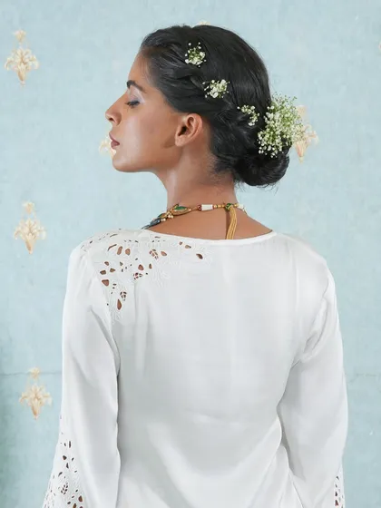 Another angle of a beautiful bridal updo. The interwoven flowers and the smooth finish are made possible by the flawless integration of our real human hair extensions.