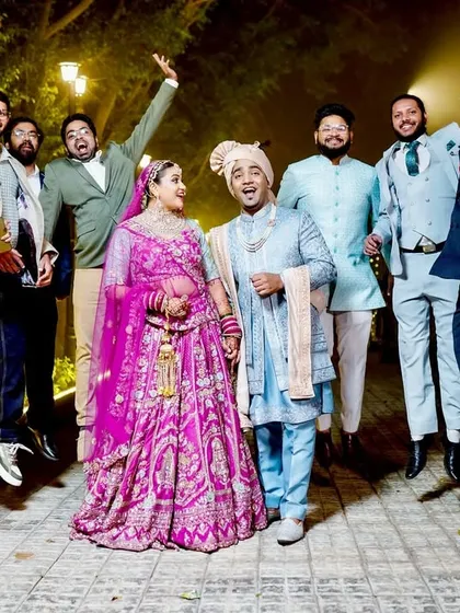 A fun and energetic photo of the couple with their friends, capturing the celebratory spirit.